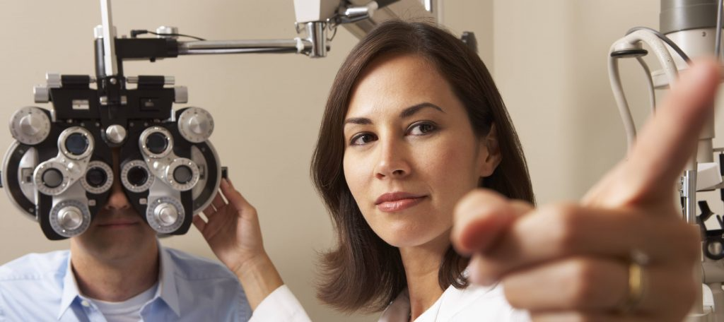 eye doctor performing checkup on patient