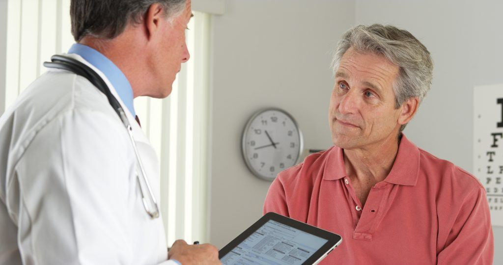 doctor with tablet talking to patient