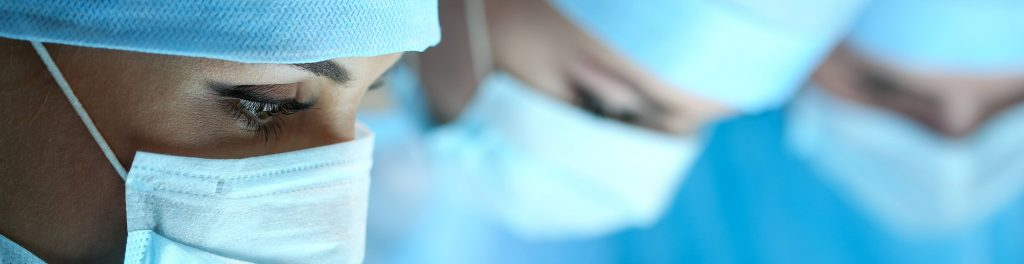 Doctors looking down wearing face masks