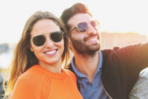 beautiful couple wearing sunglasses enjoying life in the summer