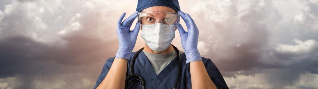Doctor adjusting safety goggles