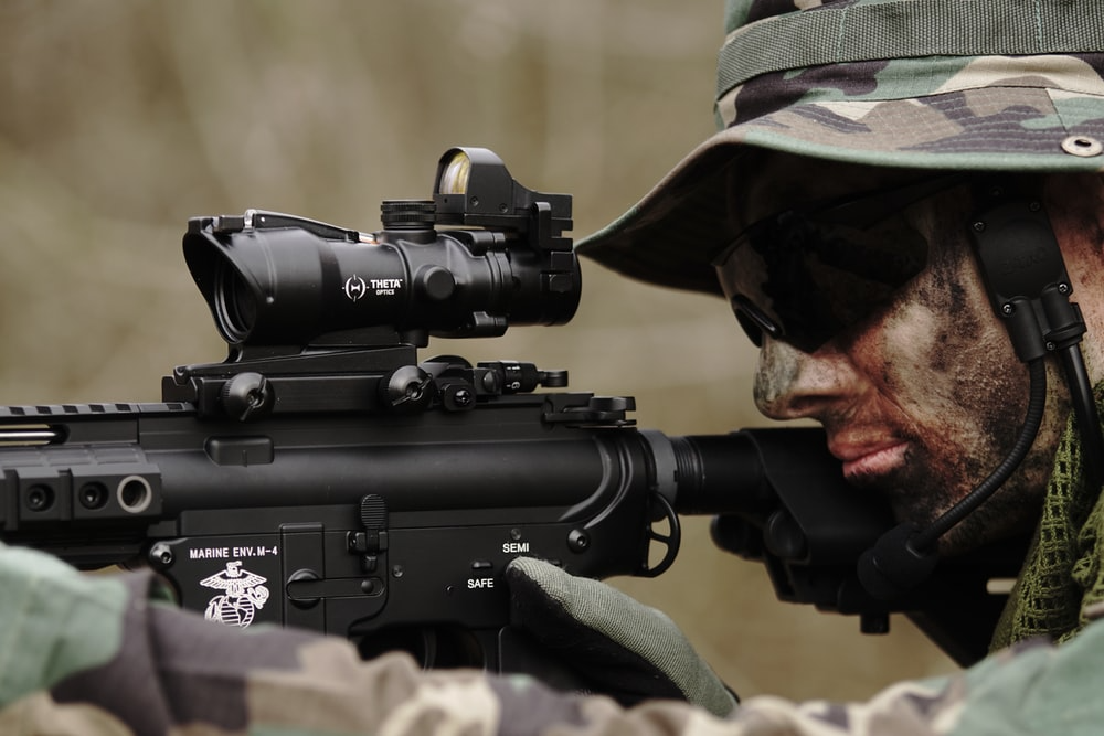 Military man aiming rifle