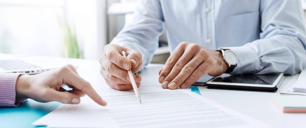 Man going over a form on a desk