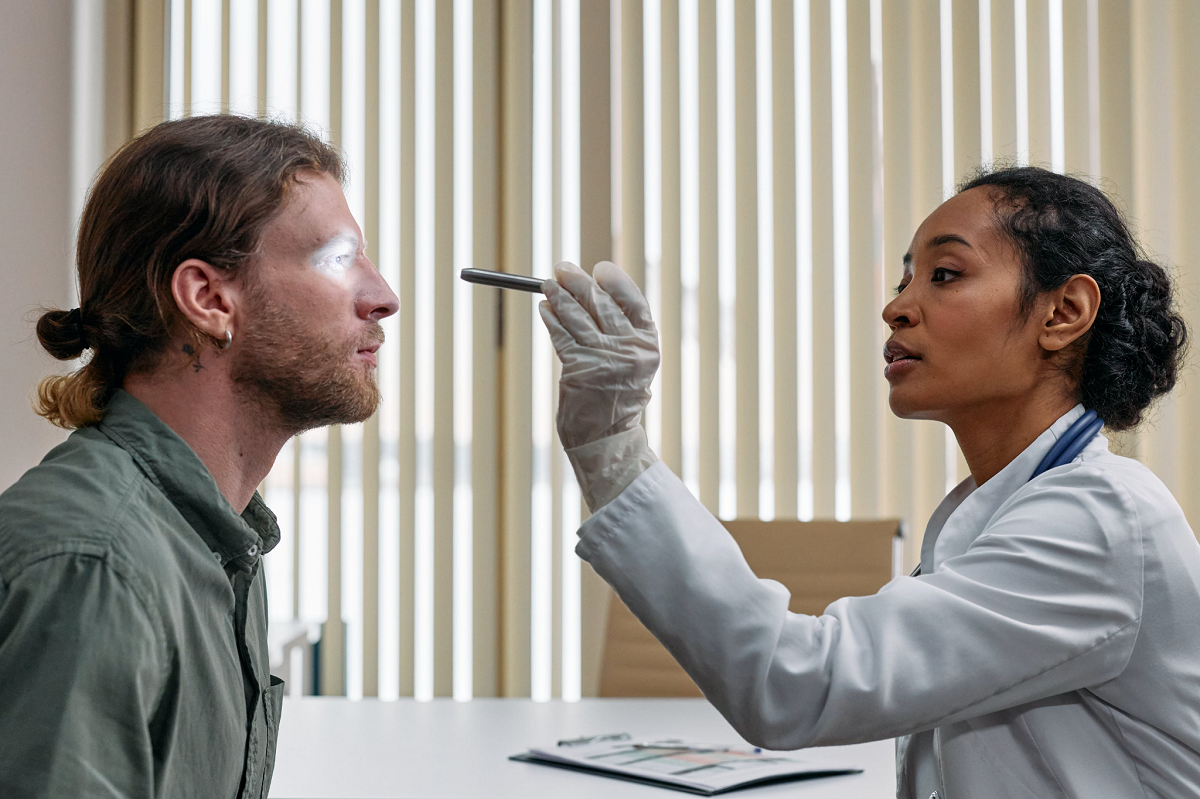 Female doctor examining patient's eyes