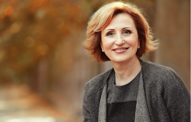middle-aged smiling woman who has had refractive lens exchange (RLE) done