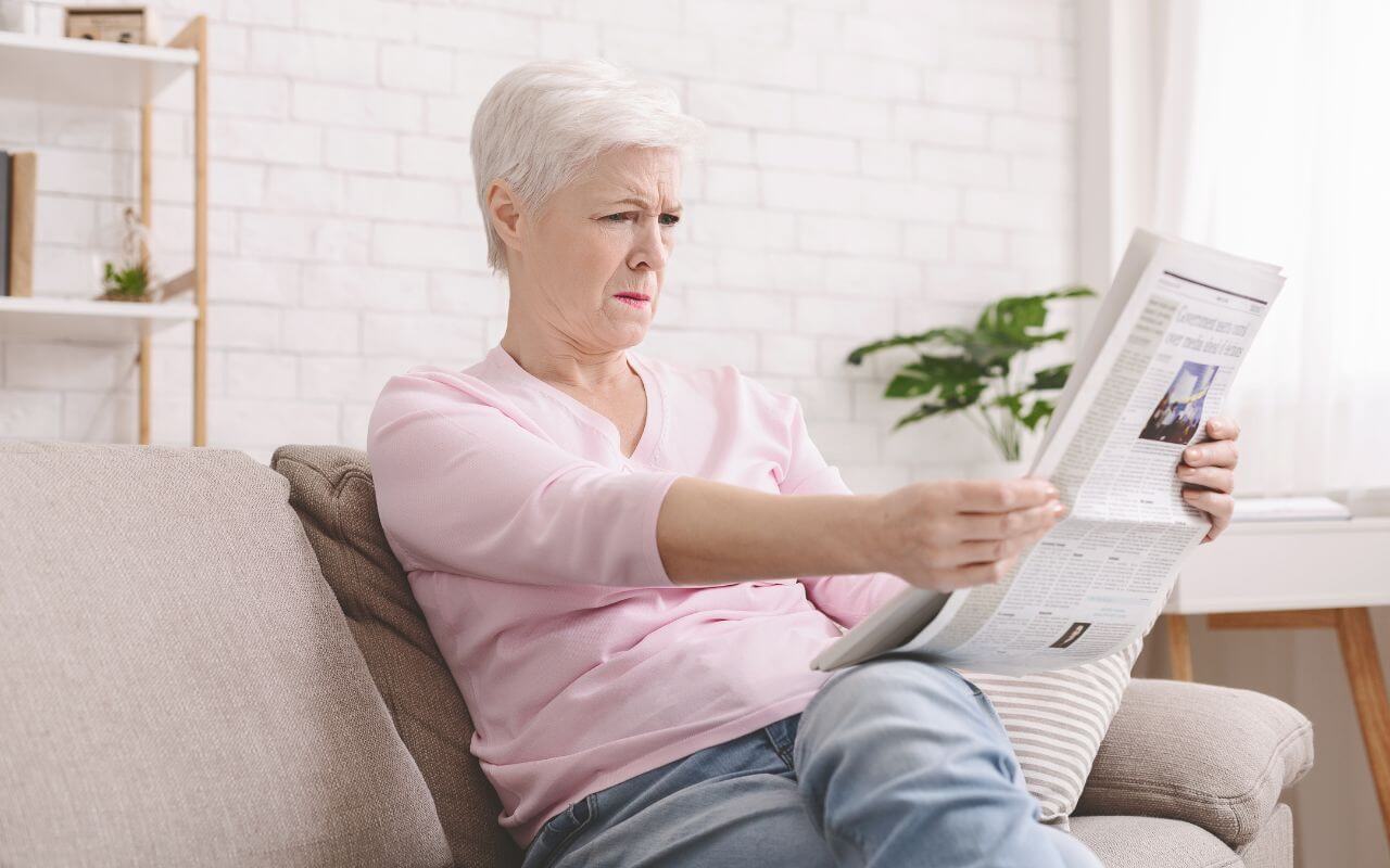 woman with cataracts struggling to read