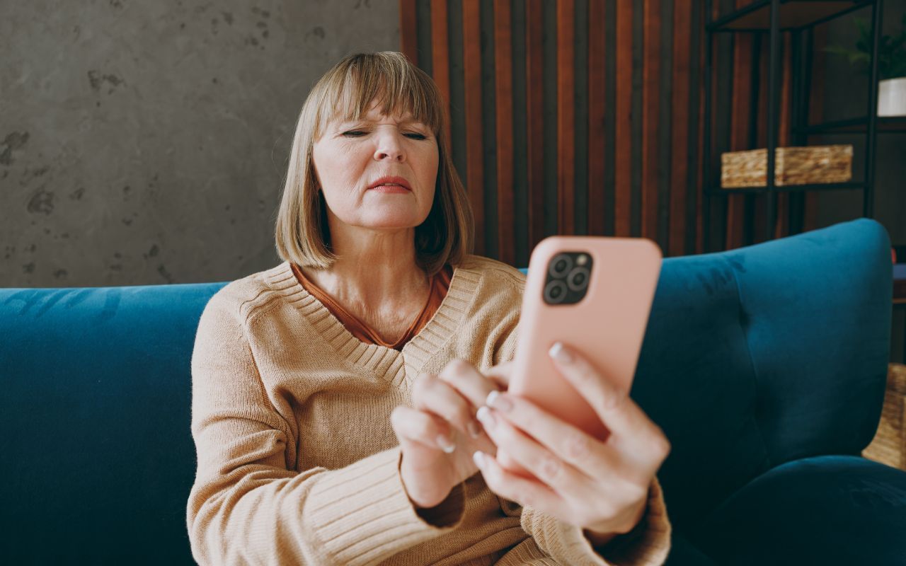 older woman squinting at the phone
