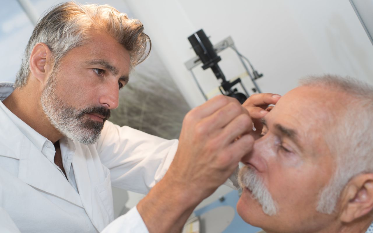 optometrist putting in eye drops patient at dlv