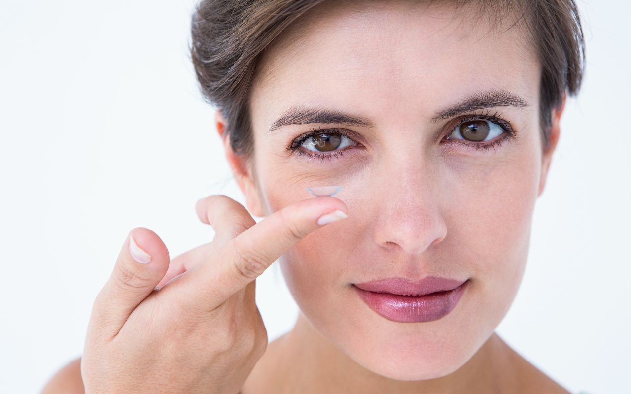 woman putting in a contact lens