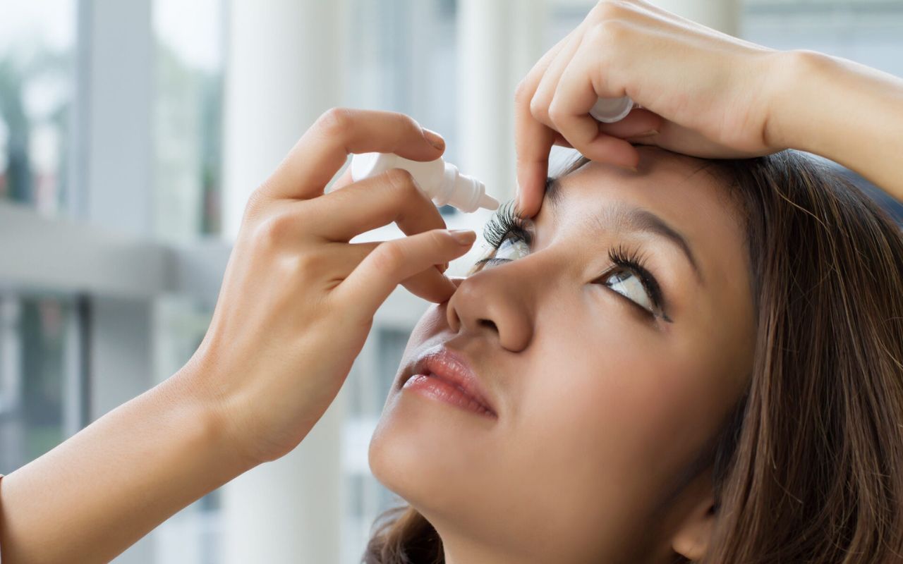 woman using eye drops