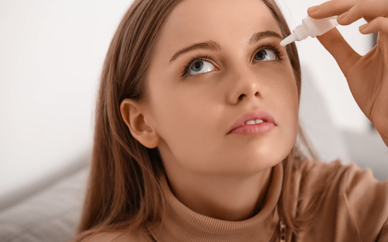 young woman using eye drops from dlv