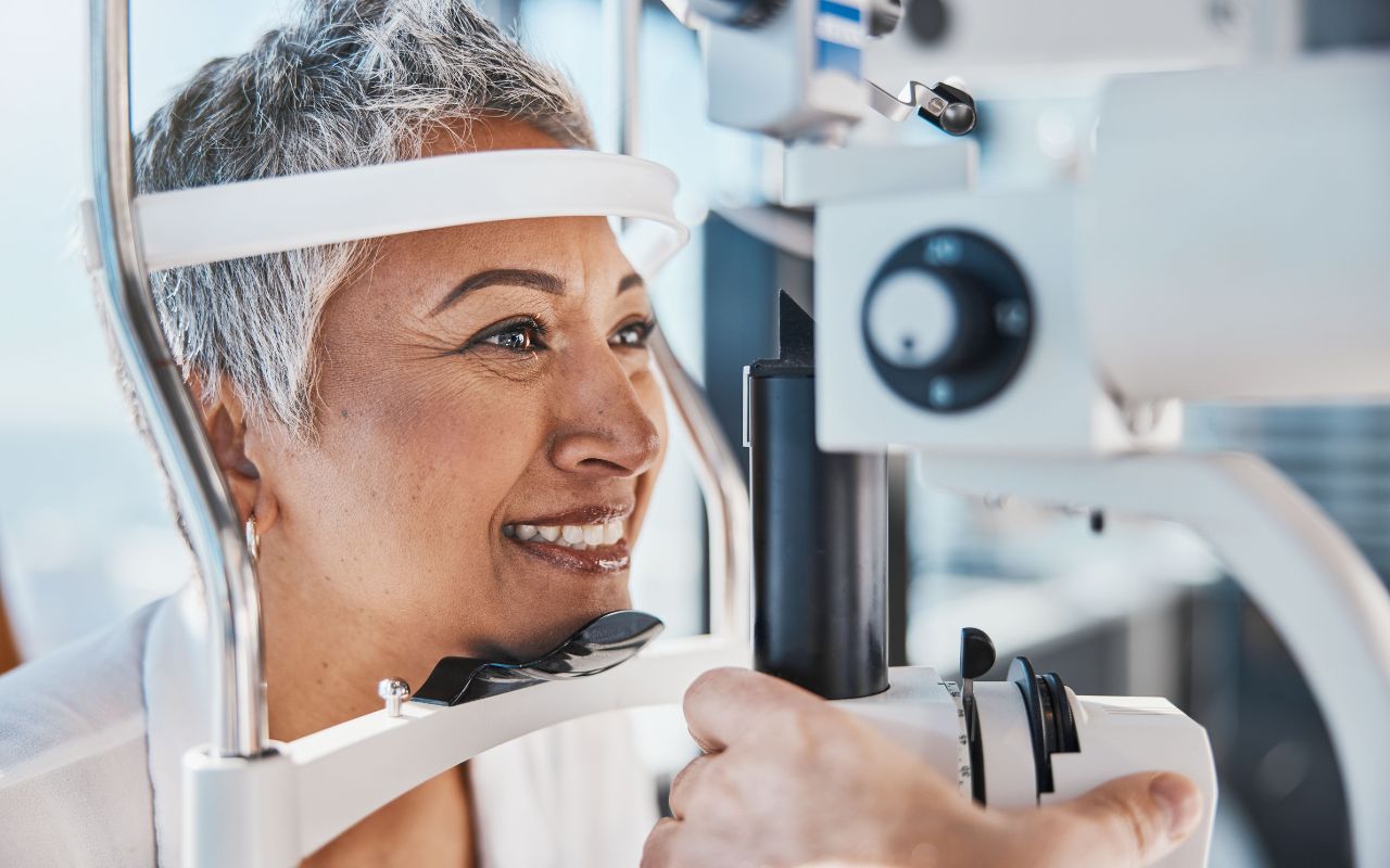 woman-getting-an-eye-exam-at-dlv (1) Smiling older woman getting an eye exam.