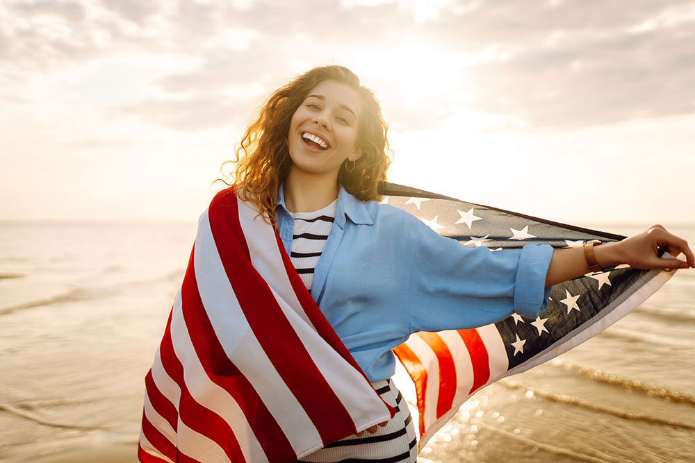 Smiling woman wrapped in an American flag